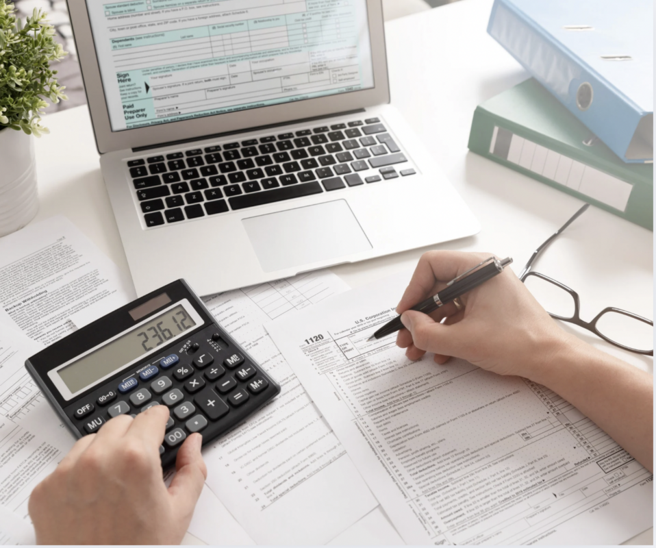 tax preparer using calculator to calculate tax return